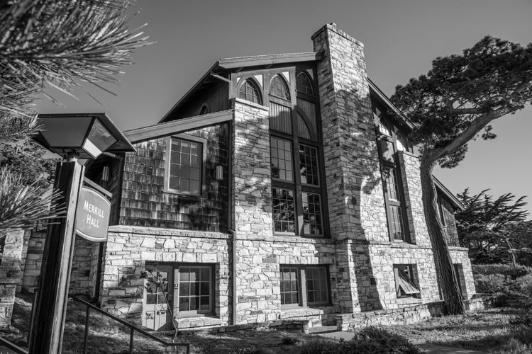 Black and white photograph of Merrill Hall, a large stone and wood building