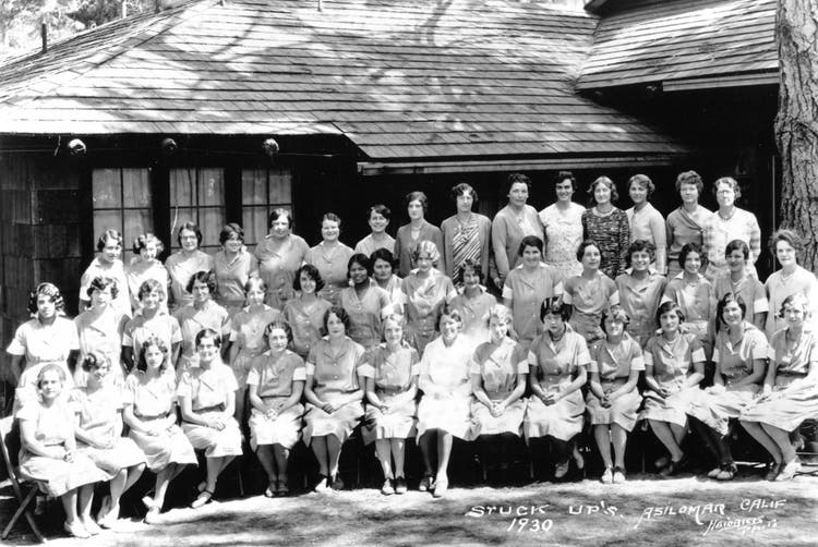 Historic 1930 group photo of women gathered outside a wood-shingled building at Asilomar.